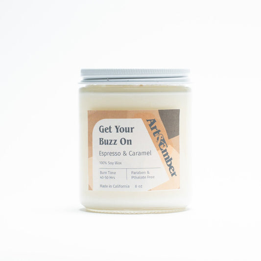 Candle jar labeled 'Get Your Buzz On' by Artisanal on a white background