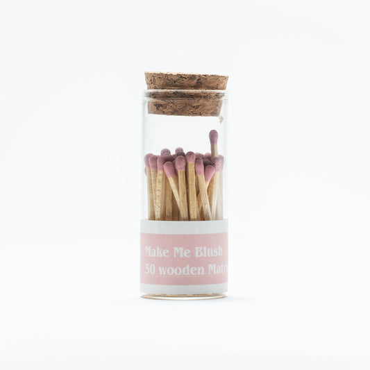 Jar of wooden matches with a cork lid on a white background